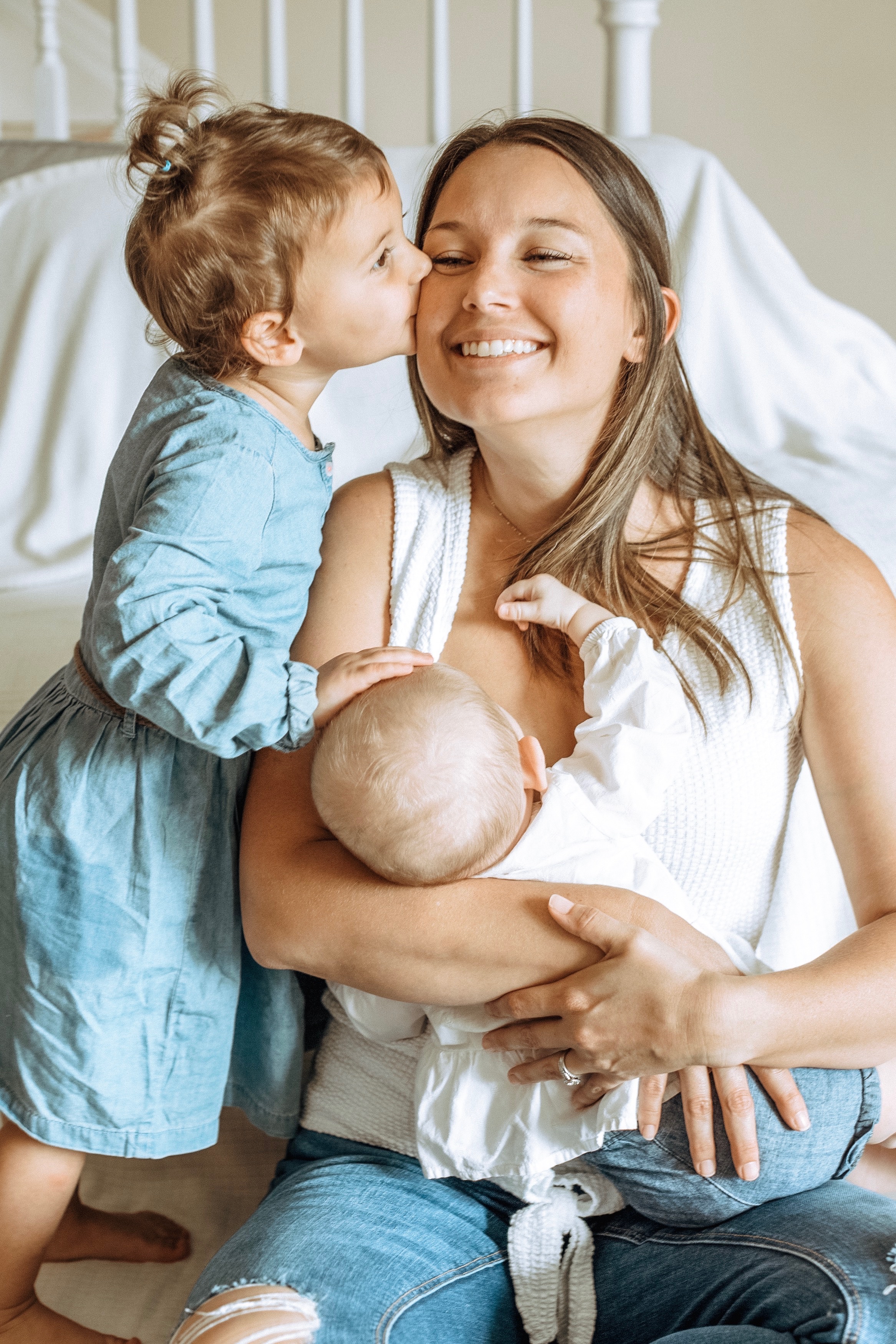 Samantha Cockerham, Upper Keys Child Development Director with the Florida Keys Healthy Start Coalition with daughters Olivia and Ella (breastfeeding) at home.