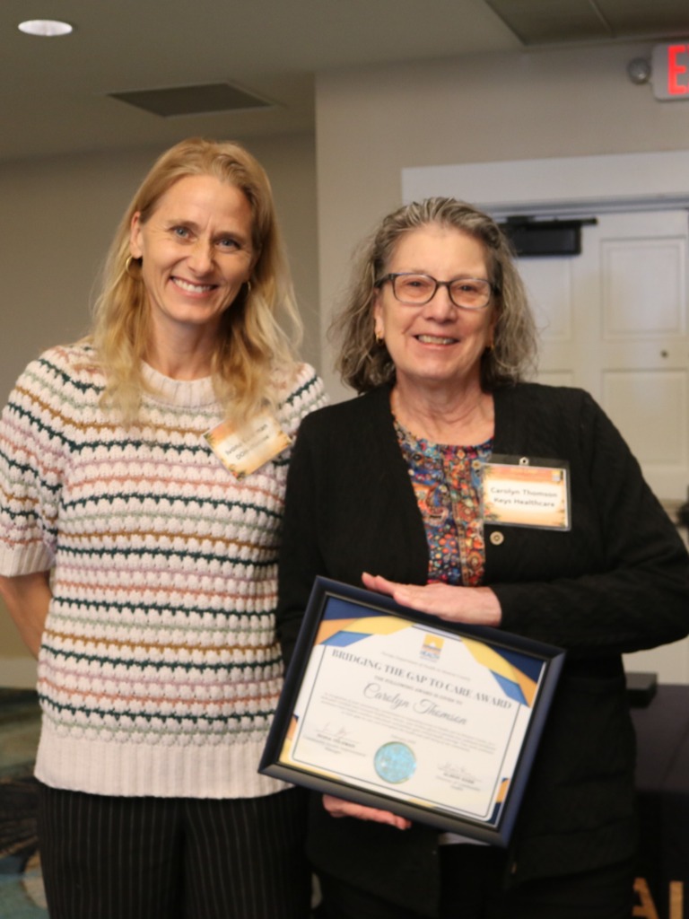 Ivona Coleman (left), with the Florida Department of Health in Monroe County, presented the Bridging the Gap To Care Award to Carolyn Thomson (right)
